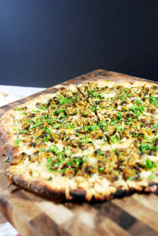 White Clam Pizza: Delicious plump clams on a pizza, paired with asiago and parmesan cheese and fresh thyme and parsley.
