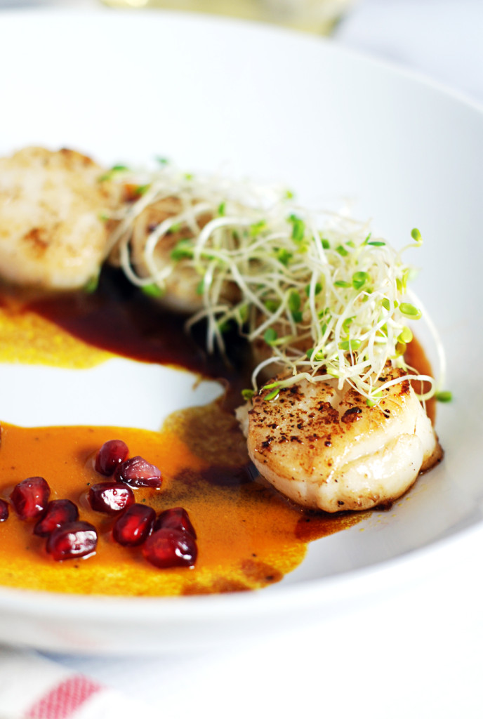 This delicious recipe for easy seared scallops is paired with a duo of beautifully refreshing pomegranate and carrot sauces.